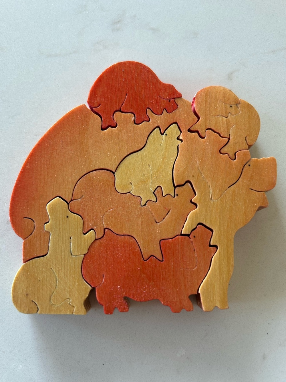 Vintage wooden nesting pigs puzzle by British artisan Carol Leith